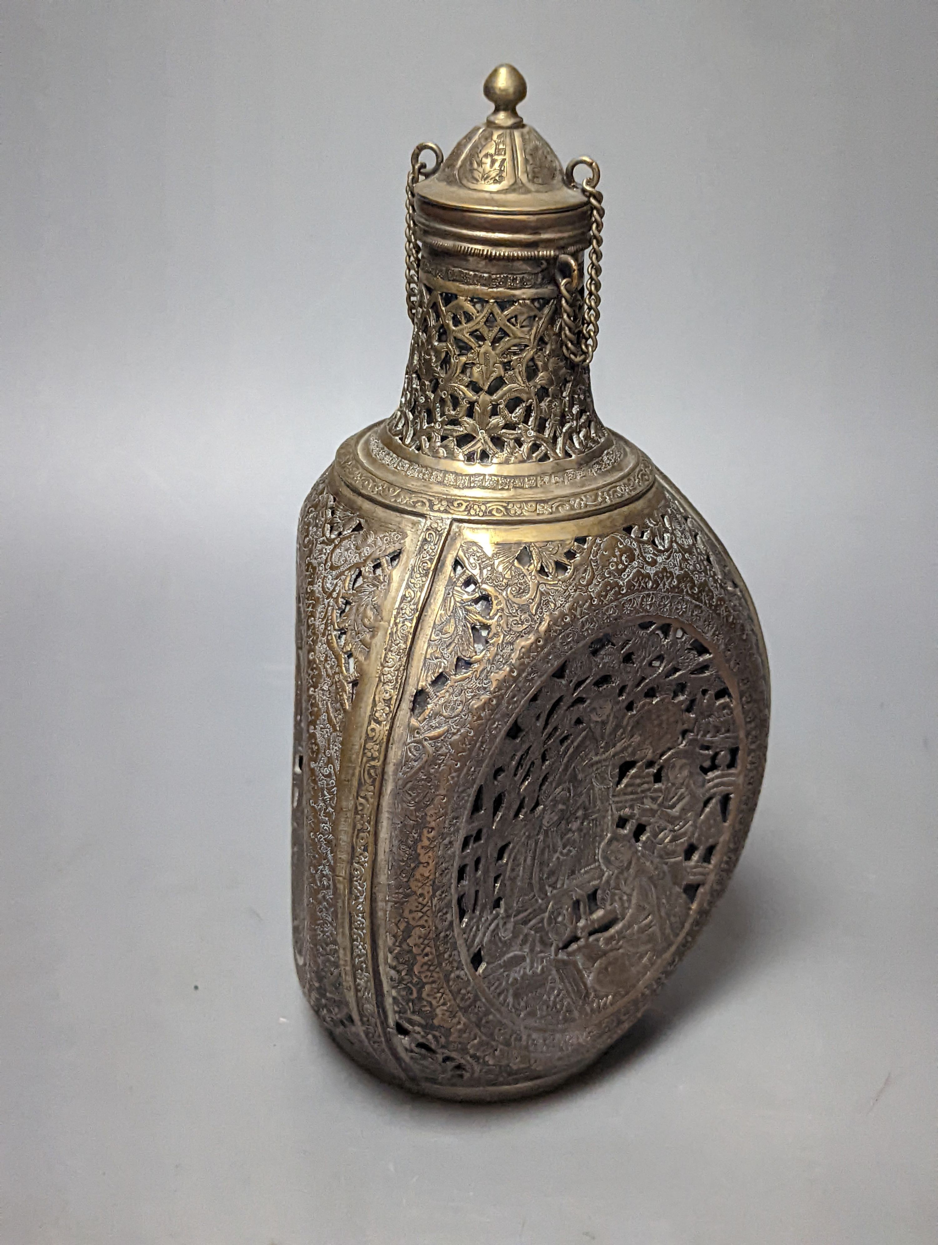 A Persian pierced brass cased glass dimple bottle 23cm